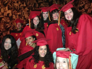 students in red robes at the graduation