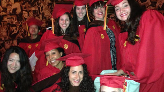 students in red robes at the graduation