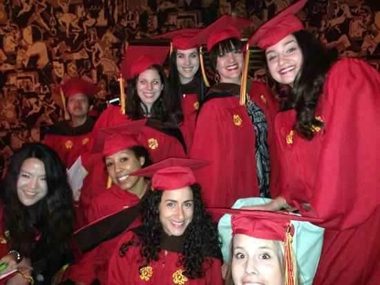 students in red robes at the graduation