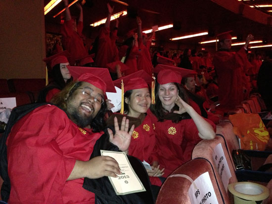 a group photo of students in red robe at graduation