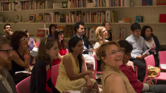 people in red chairs listening