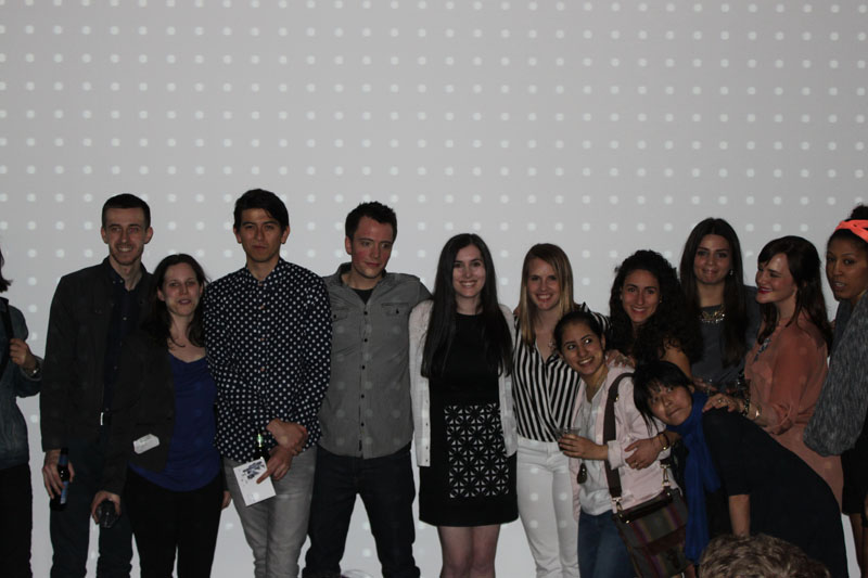 group photo of students in front of a dotted grey background