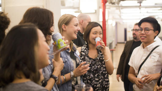 people talking and having a drink at the exhibition gallery