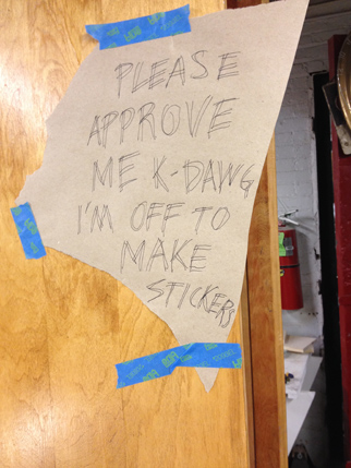 please approve me k-dawg i'm off to make stickers. written on a piece of paper stuck to a wood board