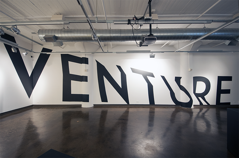 venture vinyl word installed on the wall