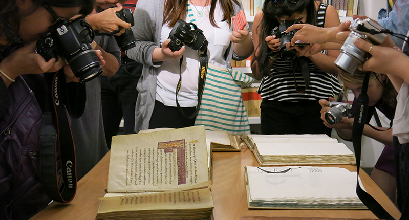 students taking photos of old books