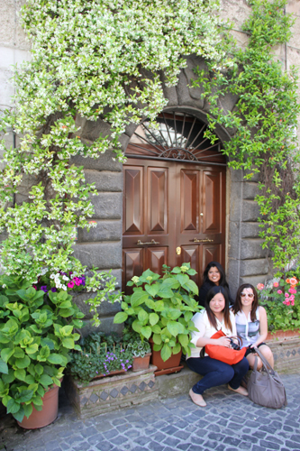 Three woman seated around green plants