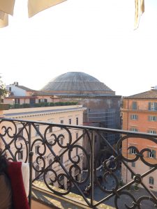 A photo of a building dome taken from the balcony of another building.