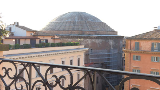 A photo of a building dome taken from the balcony of another building.