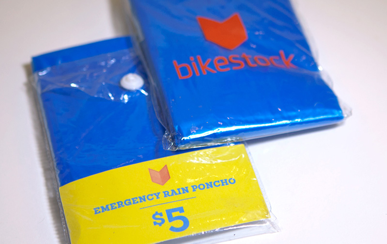 two emergency rain ponchos packed in a plastic wrap with bikestock logo on it