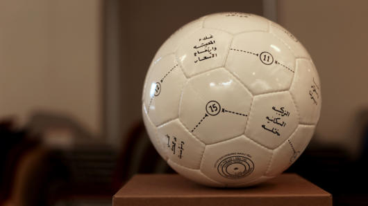 football with Arabic language written on it