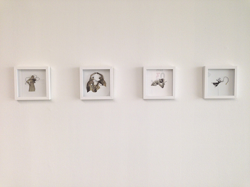 four illustrations framed in a white wooden frame are installed on a wall