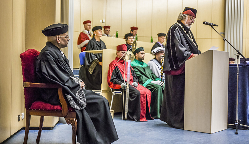 people wearing robes and one one is giving a speech