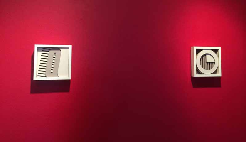 two white frames on a red wall
