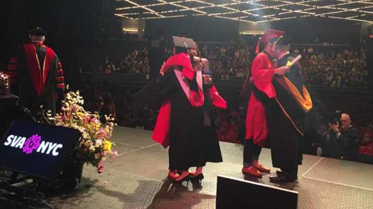 students hugging professors during graduation