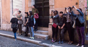 people taking photos in the street