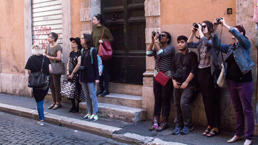 people taking photos in the street