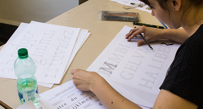 student working on a lettering exercise