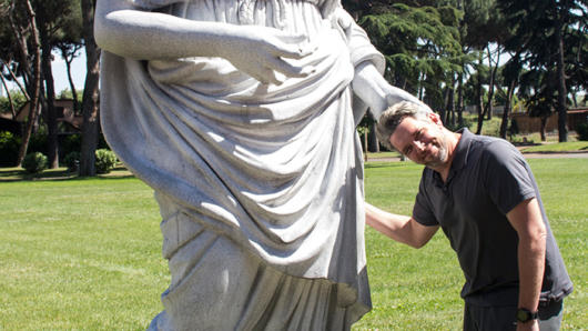 A male posing with the scupture