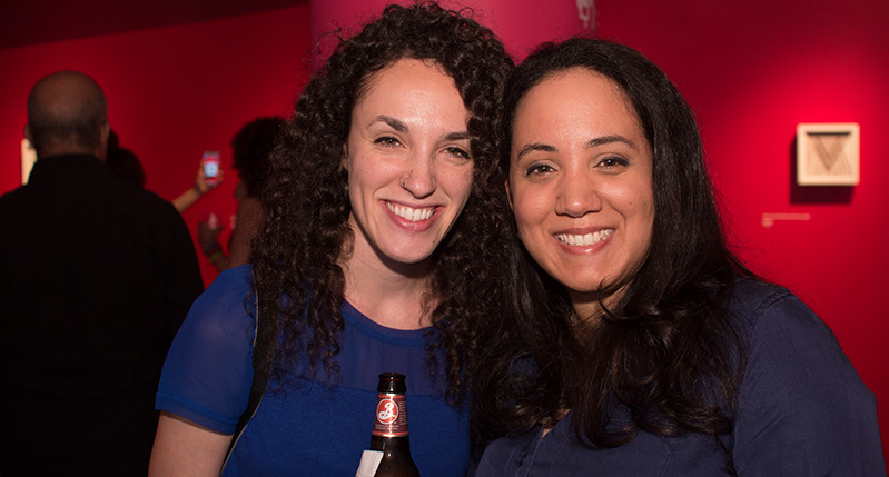 two women with blue shirt and beer