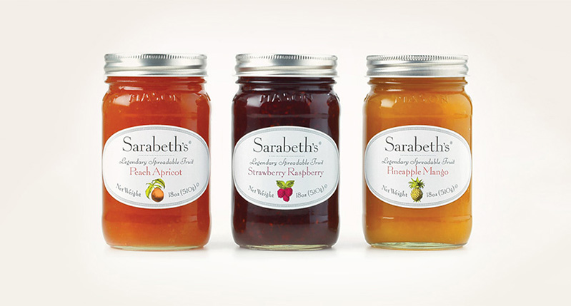 three jars of gem made of apricot and peach, strawberry and raspberry, and pineapple and mango