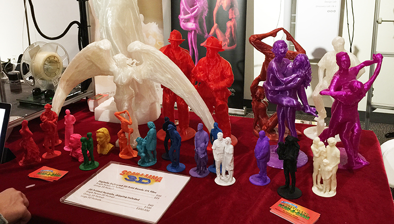 colorful sculptures displayed on a table with a price list