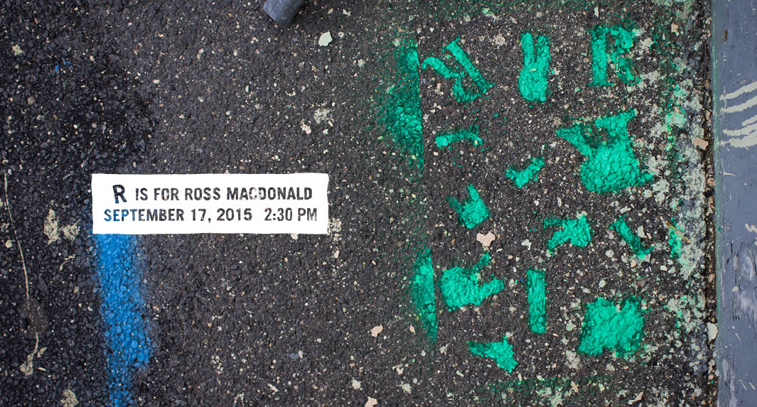 R is for Ross Macdonald event banner with an image of a street pavement covered with green and blue paint.