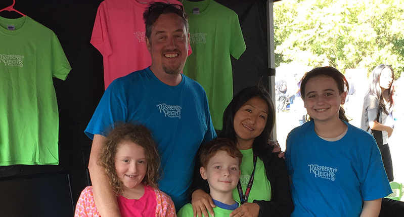 picture of a man with a few kids in a t-shirt shop