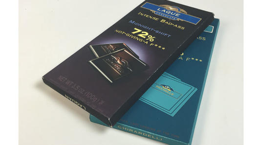 A set of chocolate packaging boxes, one black and the other blue.
