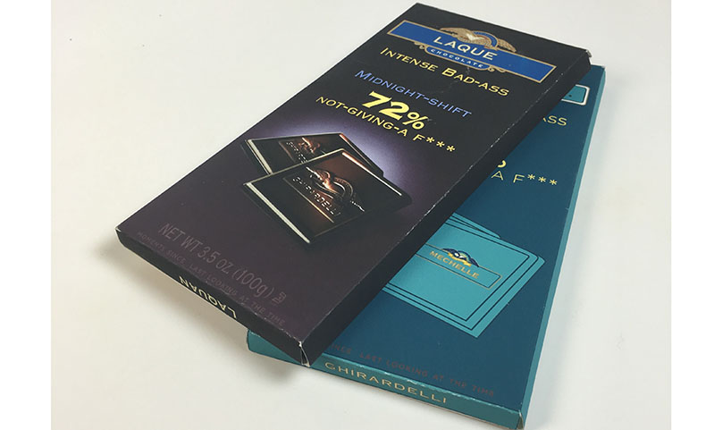 A set of chocolate packaging boxes, one black and the other blue.