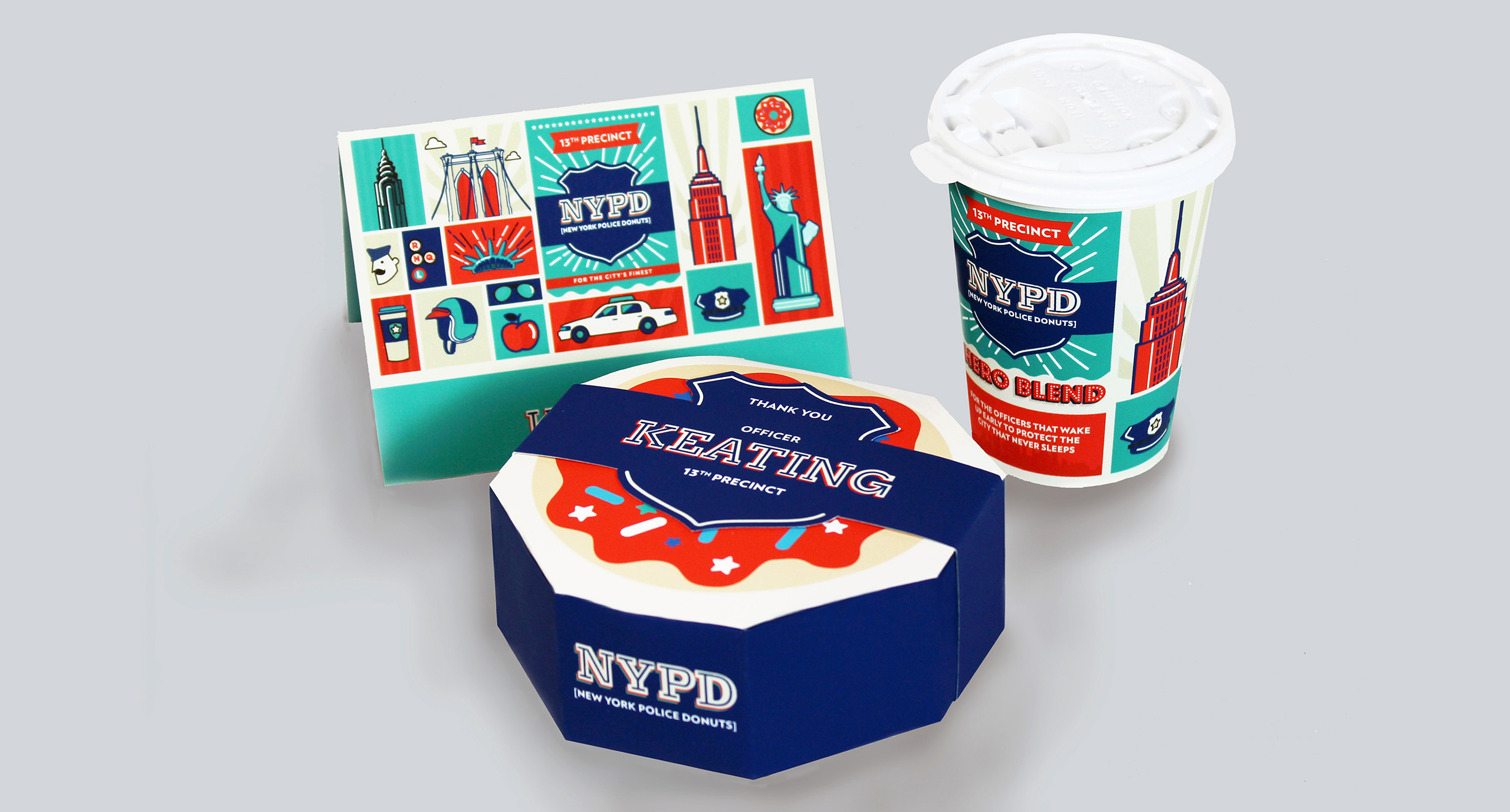 A card, a cardbox and a plastic cup of coffee, each having drawings of New York landmarks and the New York Police Department logo.