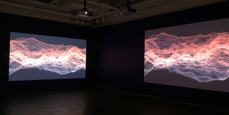 wave scope lines from red to blue projected on two walls