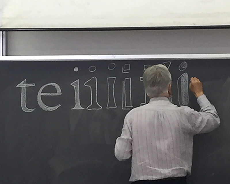 black board with man writting with chalk