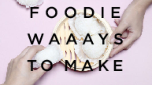 A poster with a photo of two hands, a plate and some white cupcakes. On it there is a text: Foodie Waaays To Make Friends.