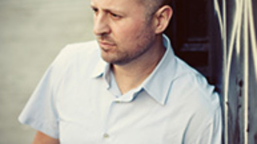 A photo of a man wearing a white shirt.