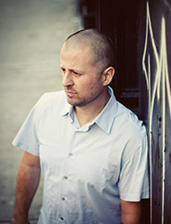 A photo of a man wearing a white shirt.