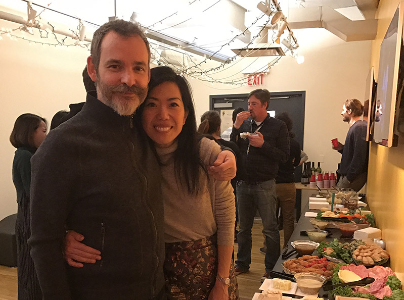 portrait of a man and a woman hugged near the snack table
