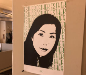 A poster with a portrait of a woman in black and white and behind her is a repeating text: ESTHER