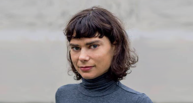 A photo of a woman wearing a blue blouse.