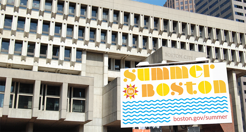 A photo of a building that has near it an advertisement with text: Summer Boston.