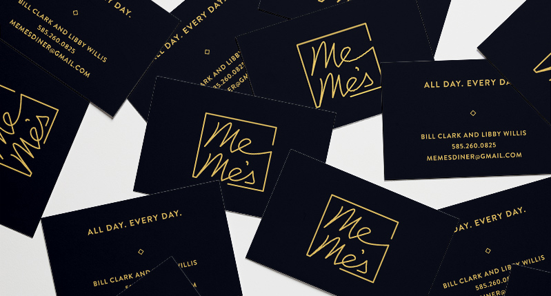A set of black cards with yellow gold logo and text that says: Me Mes.