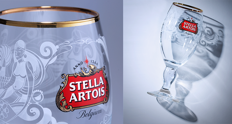 stela artois beer glass with design illustrations on it
