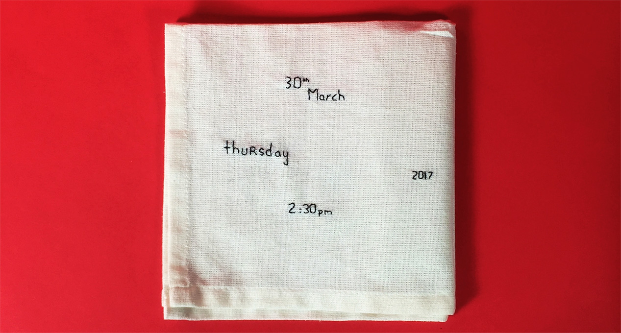 event date and time embroidered on a piece of cloth