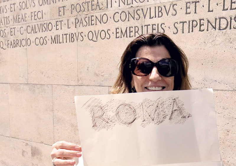 students hold a paper with ROMA pen shaved against it
