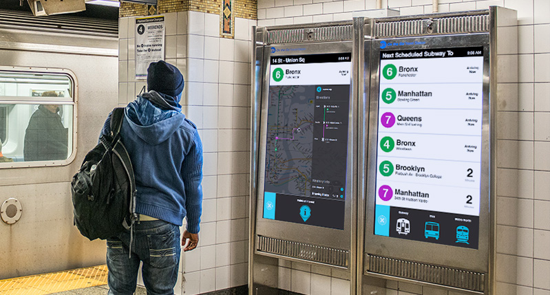 a person looks at two screens with the rout of the subway