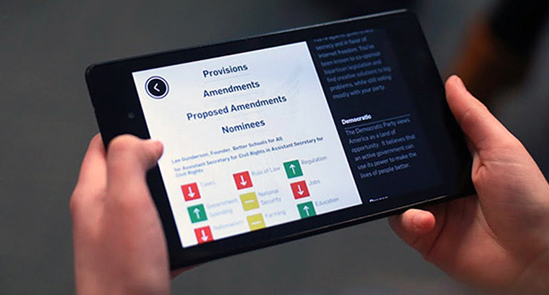 a person holds in their hands an iPad with a website displaying different information
