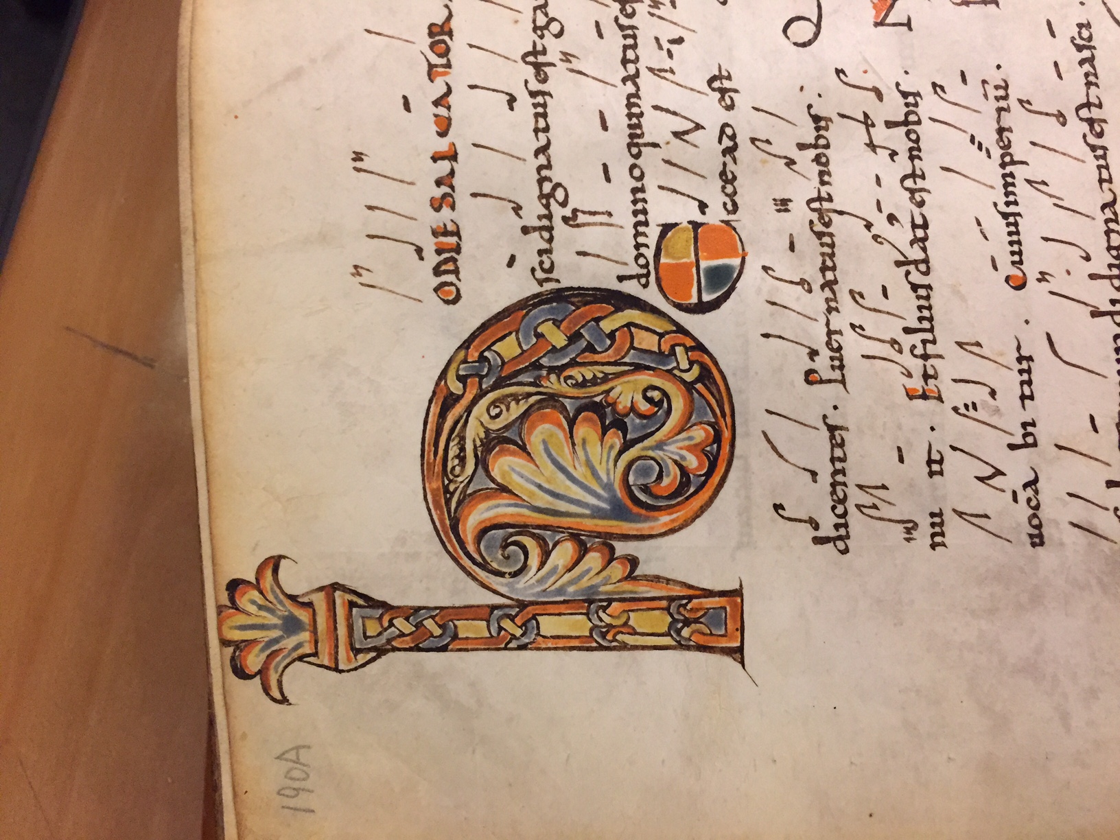 Calligraphic writing and drawing from an old book. A stylized pillar is also drawn on the page near the text.