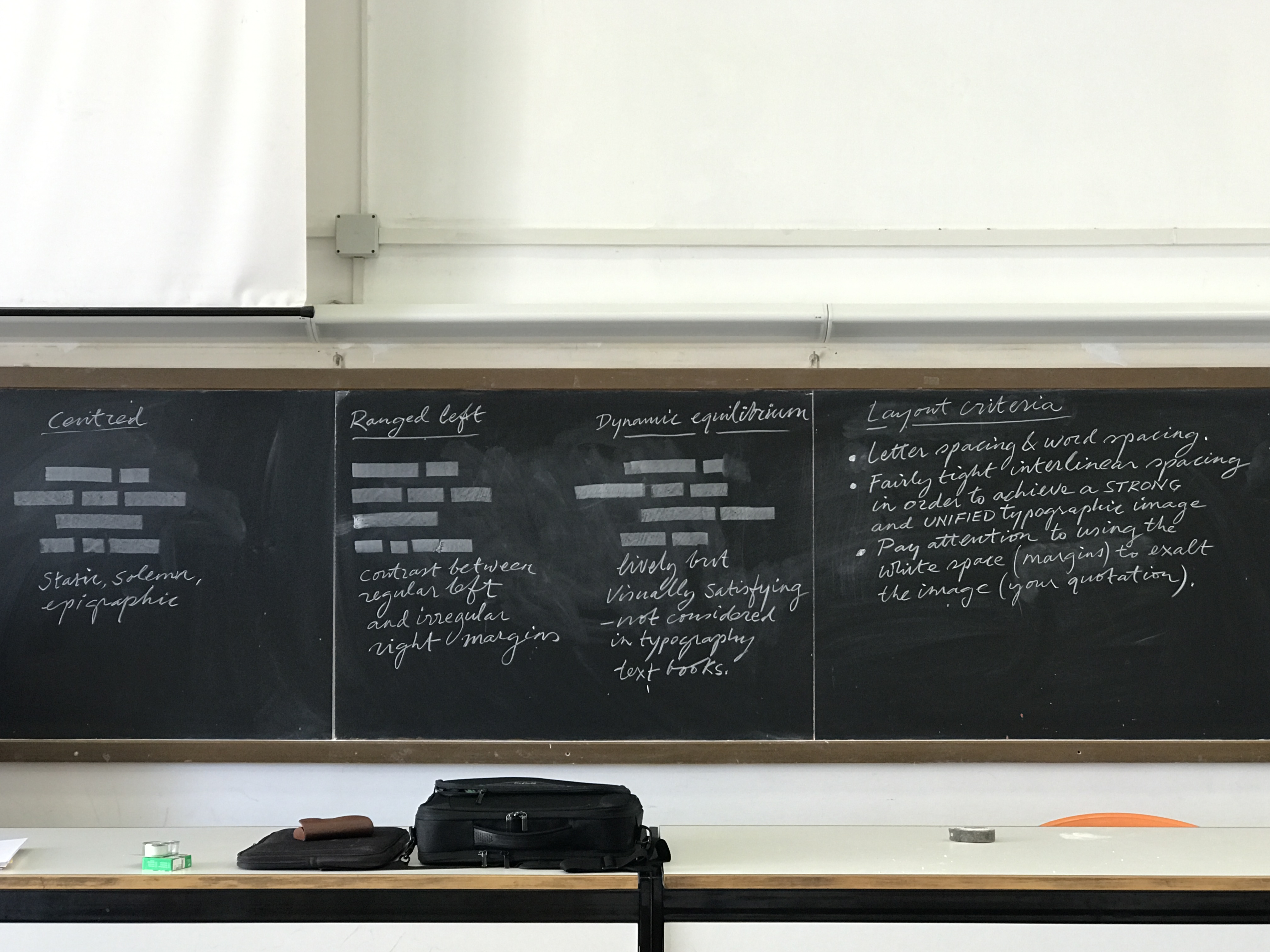 A class blackboard that has some writing on it and a bench with a backpack on it.