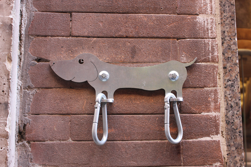 bag holders with a small dog shape applied to the wall