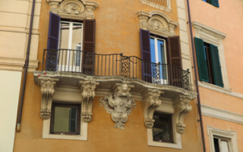 photo of window and balcony decorations of a building in Rome